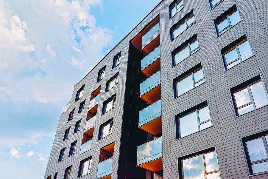 Business Insurance - Apartment Style Building with a Blue Sky